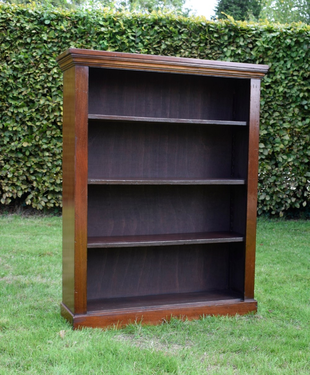 An early 20th-century open-front mahogany bookcase featuring three internal shelves, a moulded top cornice, and a sturdy plinth base. View XII