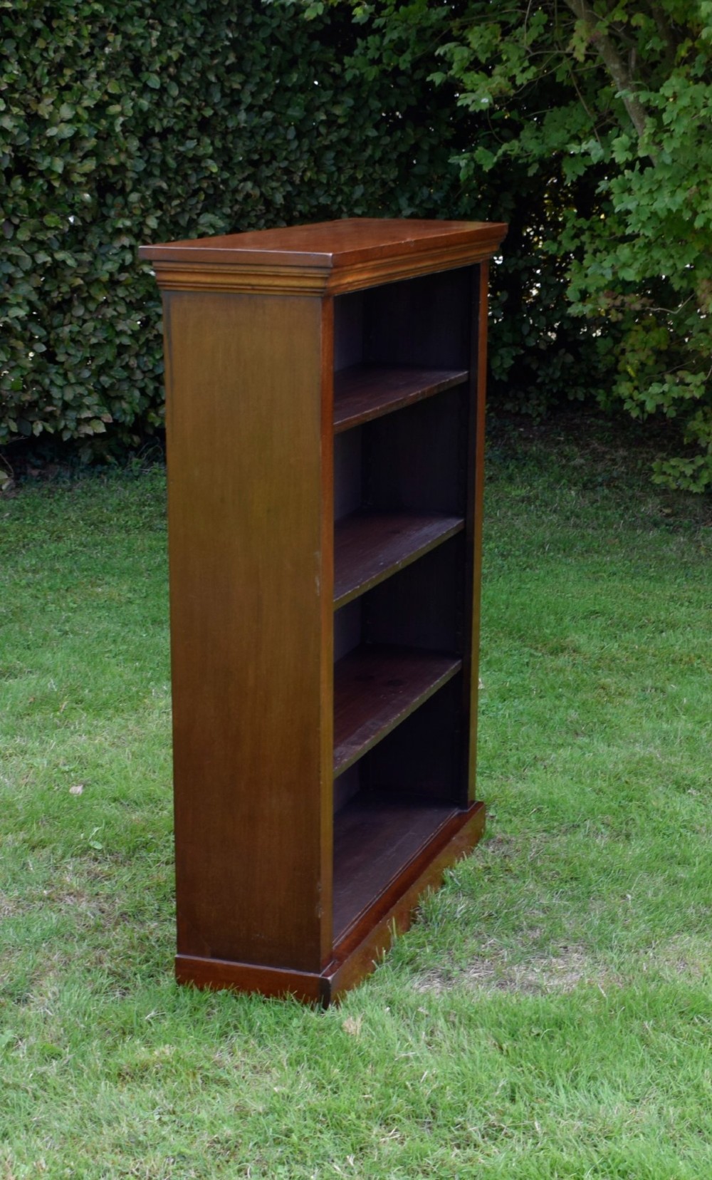 An early 20th-century open-front mahogany bookcase featuring three internal shelves, a moulded top cornice, and a sturdy plinth base. View XIII