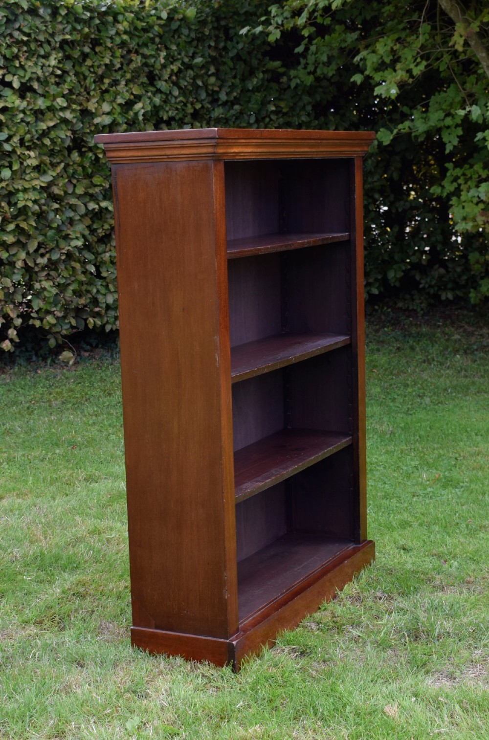 An early 20th-century open-front mahogany bookcase featuring three internal shelves, a moulded top cornice, and a sturdy plinth base. View XIV