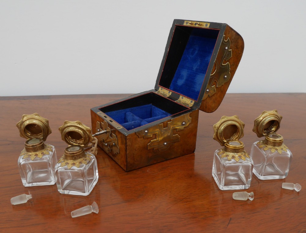 A small Victorian burr walnut scent box with decorative brass strapwork and an inserted metal key. View VI