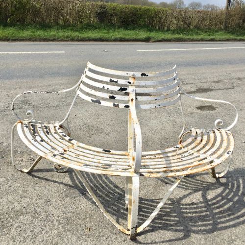 19th century demi lune wrought iron garden tree bench with layers of old paint - CATEGORY: ANTIQUE FURNITURE - DATED 19TH CENTURY