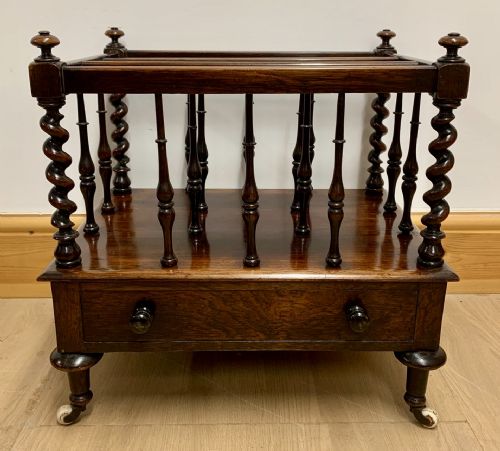 EARLY VICTORIAN ROSEWOOD CANTERBURY WITH EBONISED KNOBS AND STANDING ON BRASS CASTORS - ADDITIONAL PHOTO 1