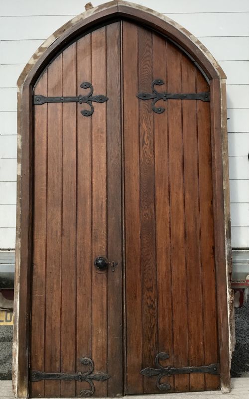 PAIR OF 19TH CENTURY ARCH TOP OAK DOORS WITH DECORATIVE HINGES AND HANDLES AND FRAME - ADDITIONAL PHOTO 1