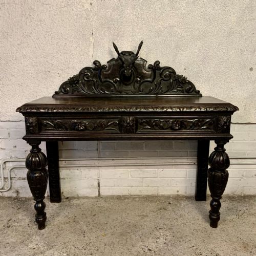 victorian carved oak side table with 2 drawers to front frieze and carved stags head to back gallery - CATEGORY: ANTIQUE TABLES - DATED VICTORIAN