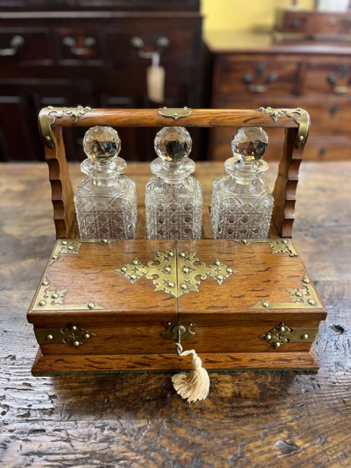 victorian oak tantalus with three cut glass decanters - CATEGORY: ANTIQUE GLASS - DATED VICTORIAN