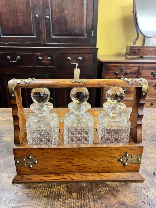 VICTORIAN OAK TANTALUS WITH THREE CUT GLASS DECANTERS - ADDITIONAL PHOTO 1