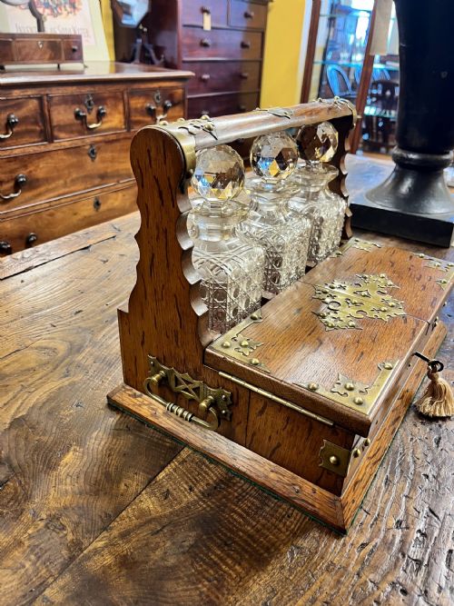 VICTORIAN OAK TANTALUS WITH THREE CUT GLASS DECANTERS - ADDITIONAL PHOTO 4