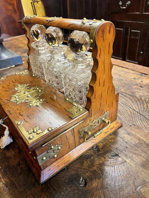 VICTORIAN OAK TANTALUS WITH THREE CUT GLASS DECANTERS - ADDITIONAL PHOTO 5
