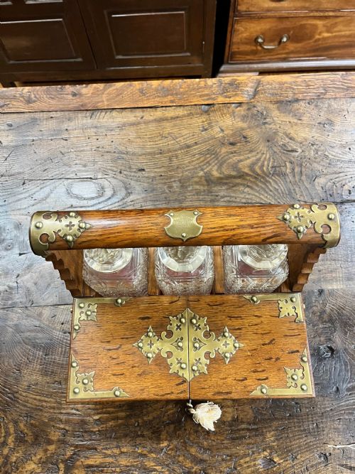VICTORIAN OAK TANTALUS WITH THREE CUT GLASS DECANTERS - ADDITIONAL PHOTO 9
