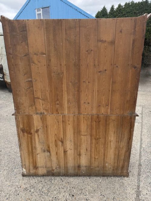 fig 1. A dark stained Victorian pine dresser featuring a three-door glazed upper display cabinet over a base with three central drawers and two panelled cupboard doors.