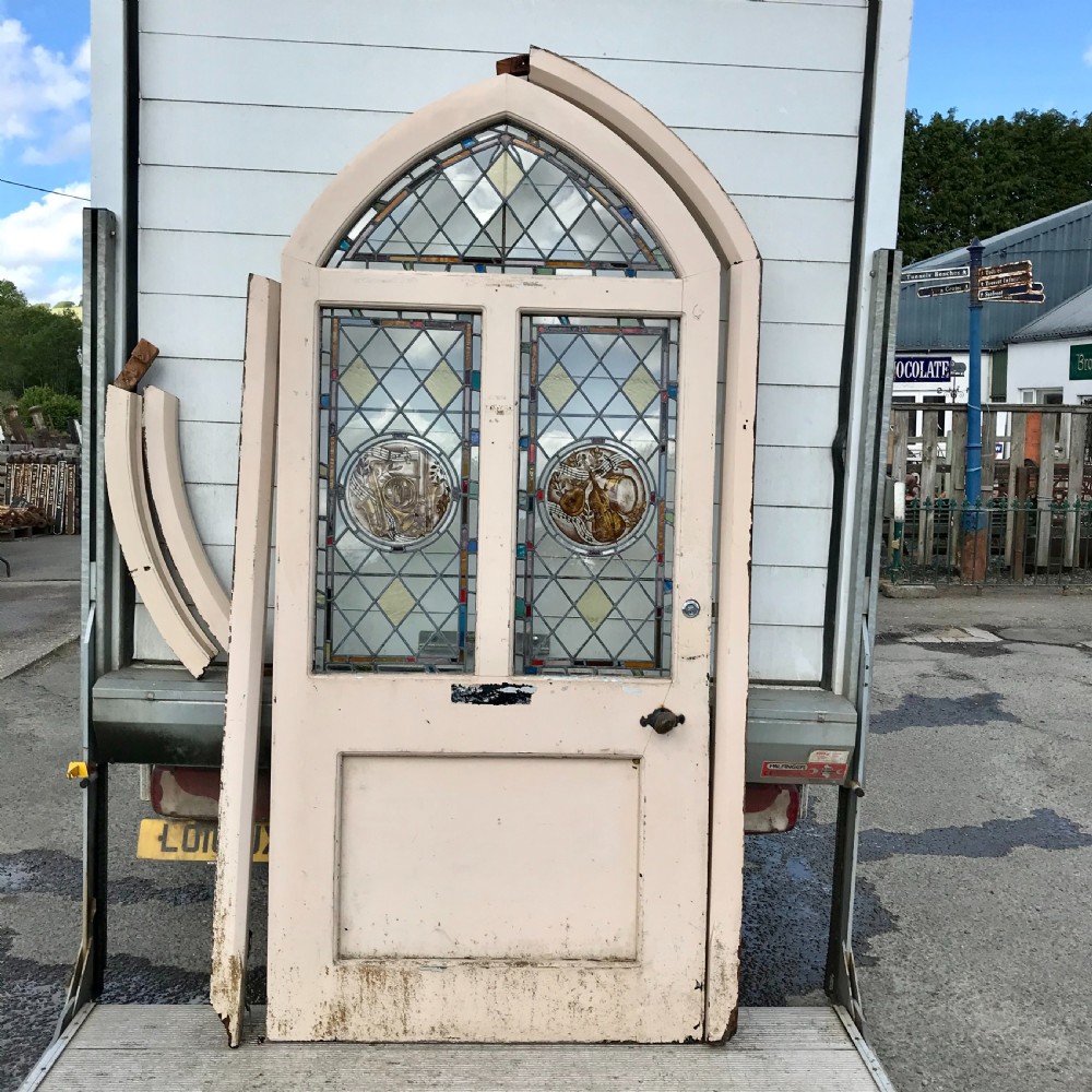 Victorian Arch Top External Pine Door with Stained Glass Panels depicting Musical Instruments and Original Frame 