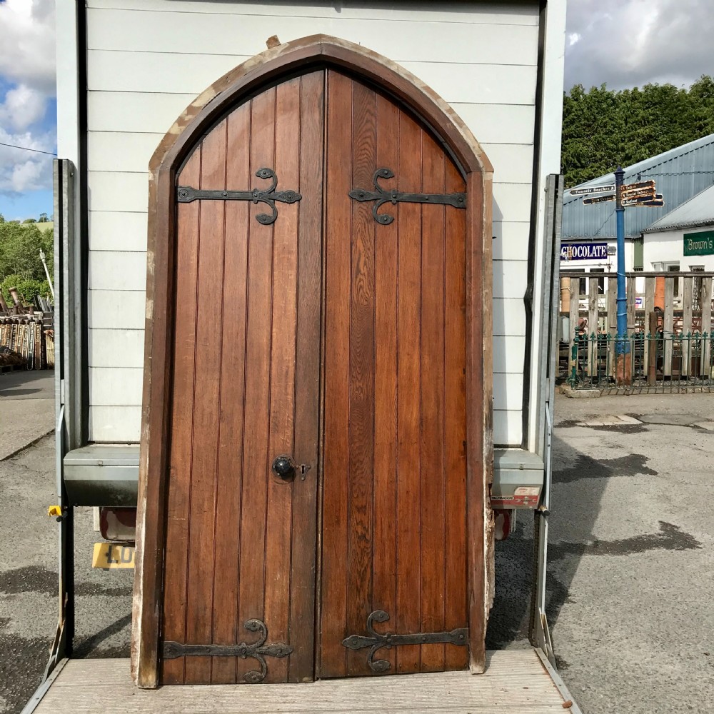 Pair of 19th Century Arch Top Oak Doors with Decorative Hinges and Handles and Frame