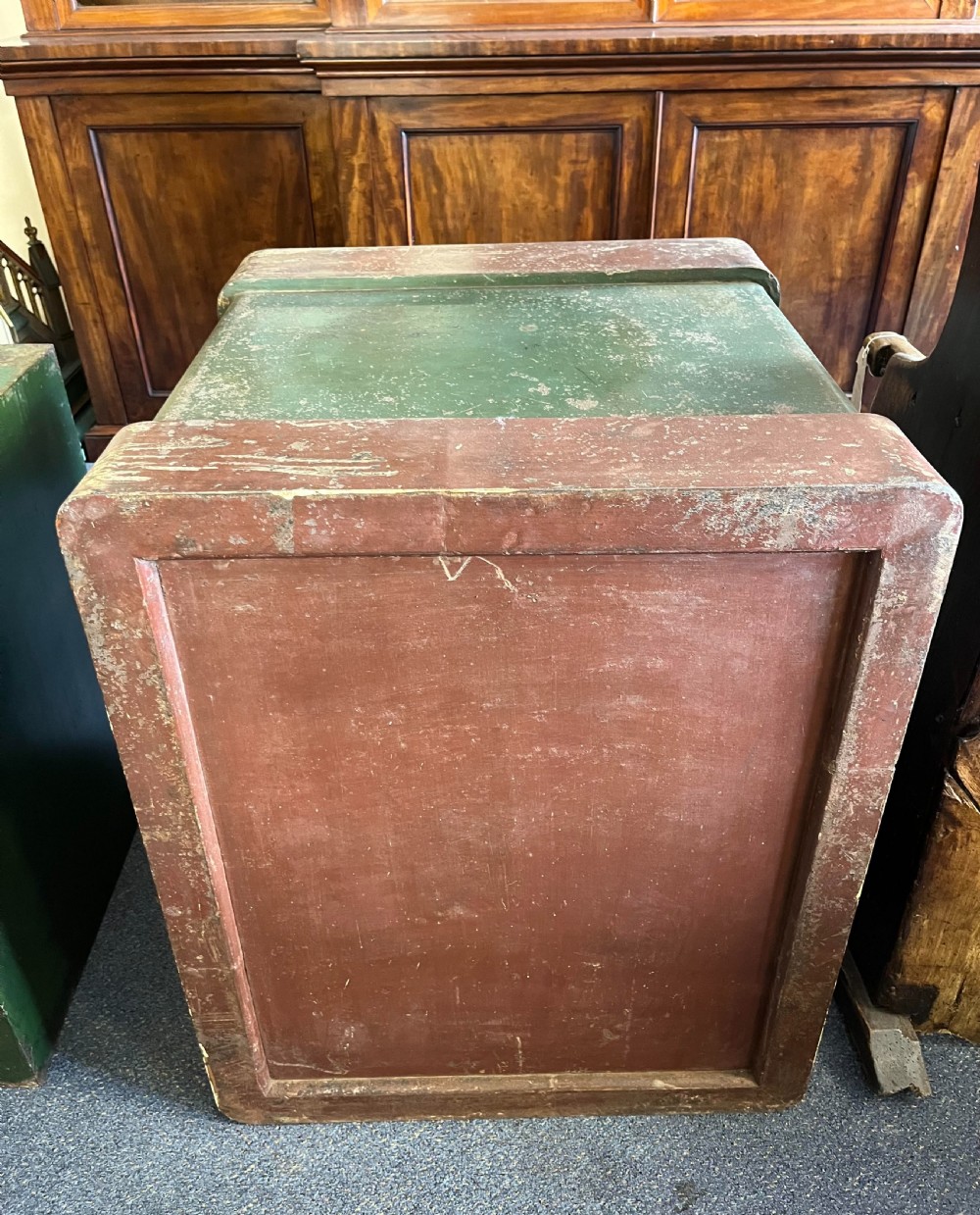 A heavy turn-of-the-century Milners iron safe featuring dark green painted panels, a brass crest emblem, and decorative corner detailing. View V