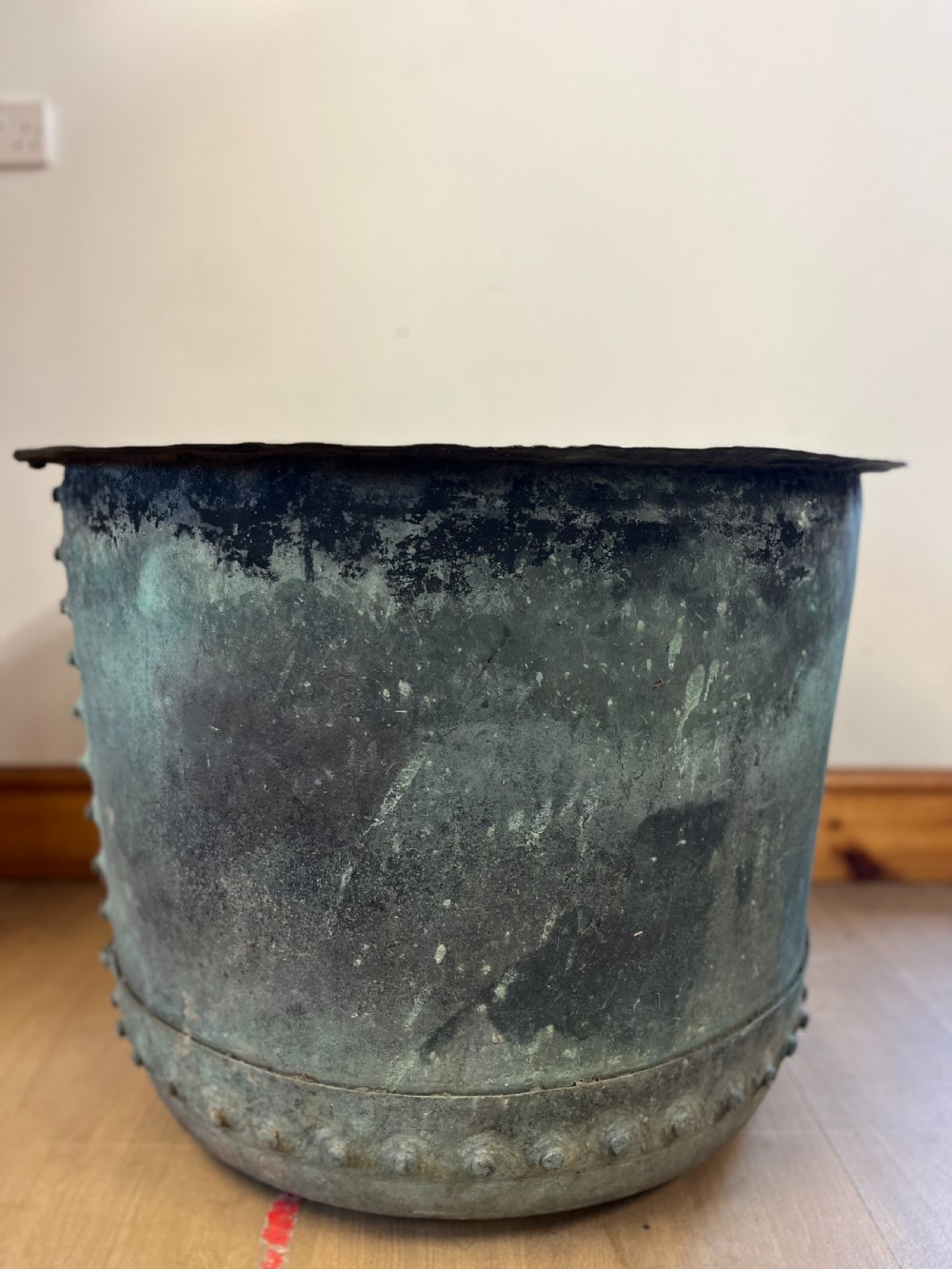 A large 19th-century cylindrical copper wash boiler featuring riveted seams and a heavily oxidized verdigris surface. View II