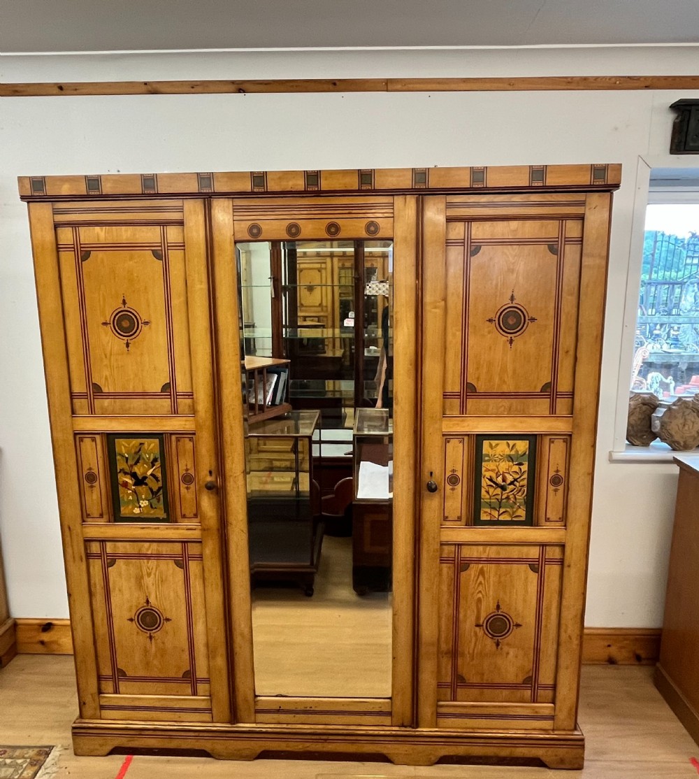 A Stunning Aesthetic Movement Ash Triple Wardrobe with Hand Painted Detail 