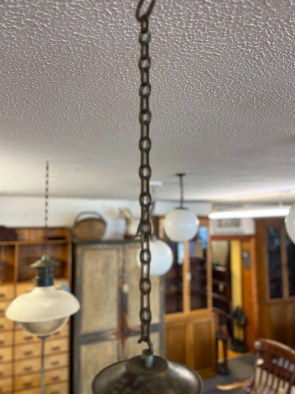 An early twentieth-century double prismatic holophane glass pendant light with a slotted metal gallery and suspension hook. View III