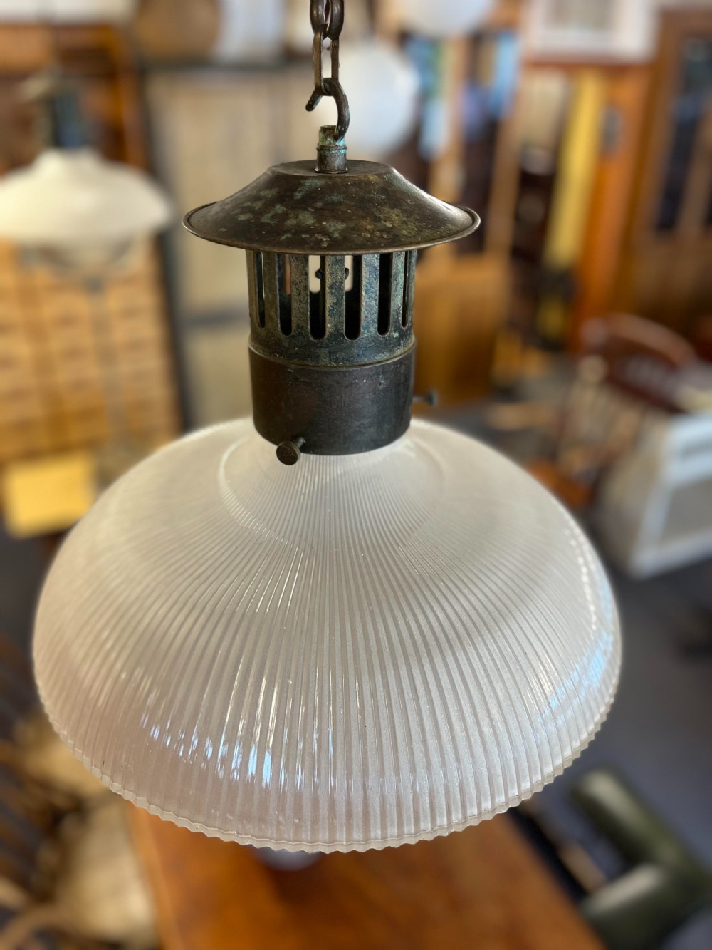 An early twentieth-century double prismatic holophane glass pendant light with a slotted metal gallery and suspension hook. View IV
