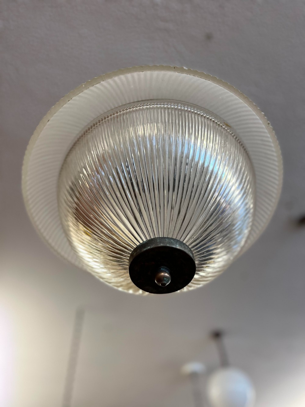 An early twentieth-century double prismatic holophane glass pendant light with a slotted metal gallery and suspension hook. View VI