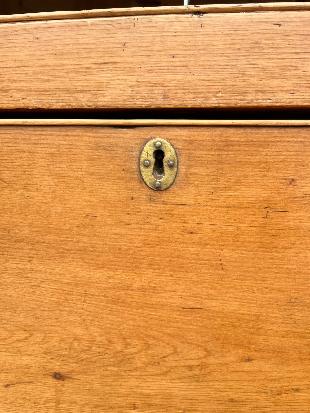 An early 19th-century Georgian pine linen cupboard featuring two upper panelled doors over two wide drawers with wooden turned knobs. View VIII