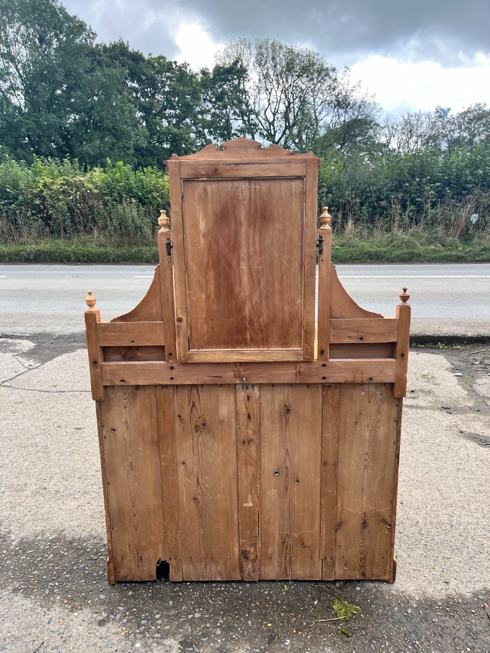 A Victorian pine dressing chest featuring a central swivel mirror flanked by two small trinket drawers, positioned above a base containing two short drawers and two long drawers with metal drop handles. View IV