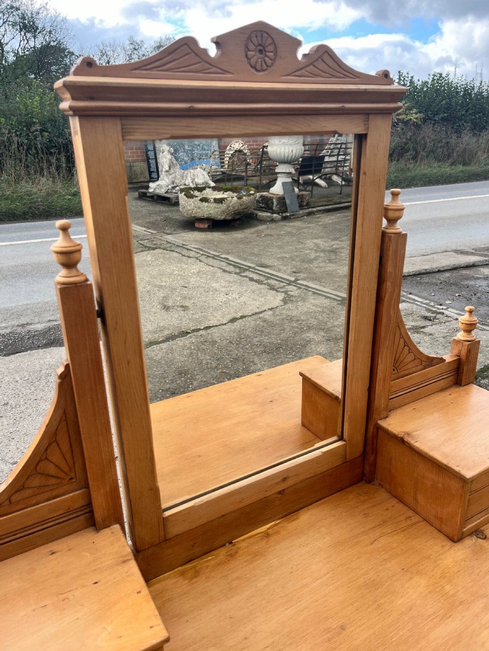 A Victorian pine dressing chest featuring a central swivel mirror flanked by two small trinket drawers, positioned above a base containing two short drawers and two long drawers with metal drop handles. View VI