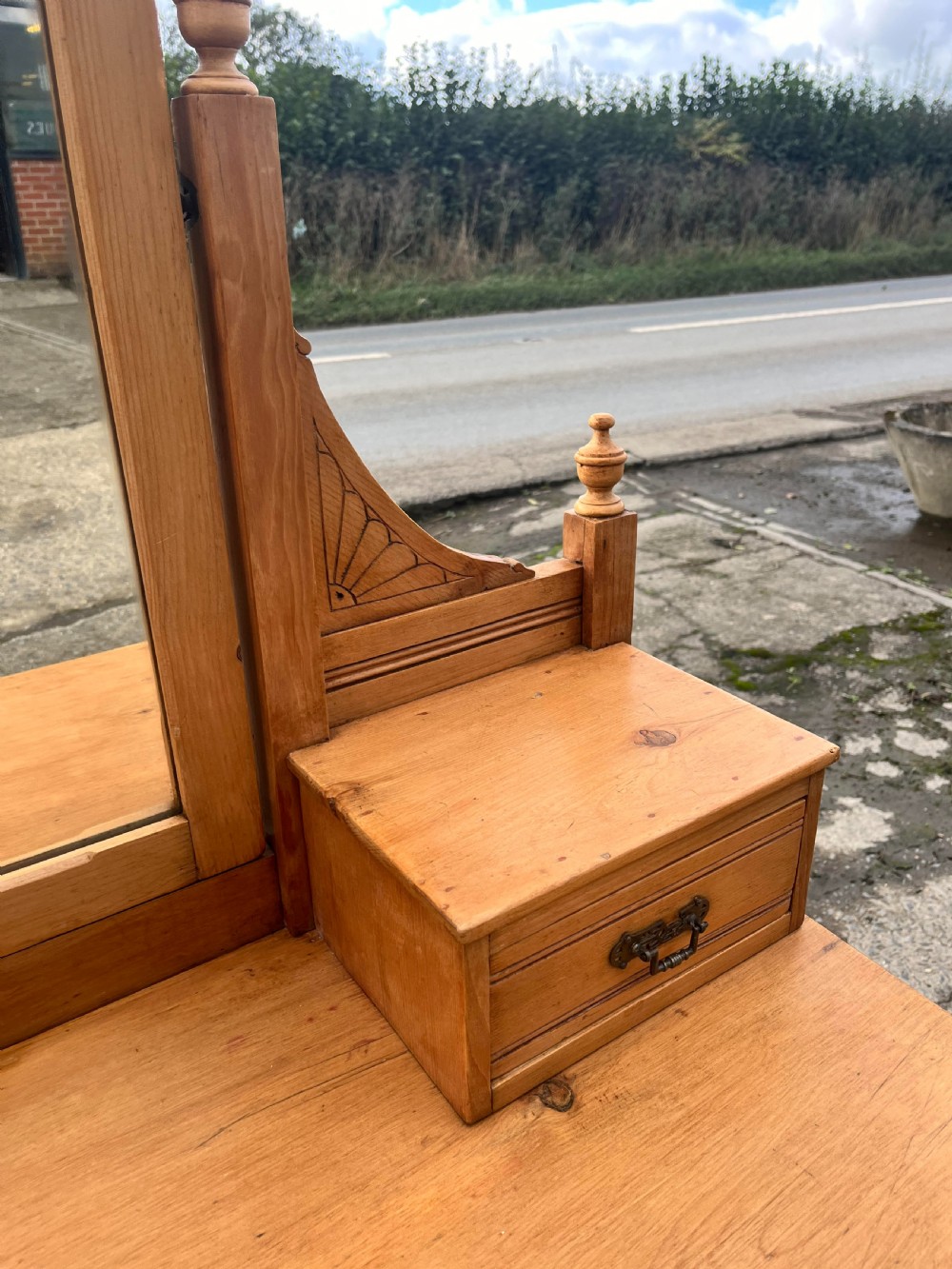 A Victorian pine dressing chest featuring a central swivel mirror flanked by two small trinket drawers, positioned above a base containing two short drawers and two long drawers with metal drop handles. View VII