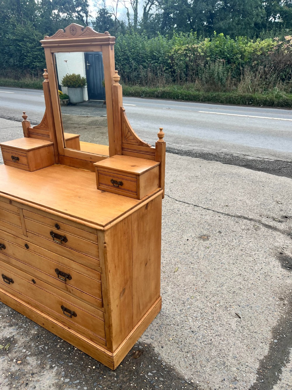 A Victorian pine dressing chest featuring a central swivel mirror flanked by two small trinket drawers, positioned above a base containing two short drawers and two long drawers with metal drop handles. View IX