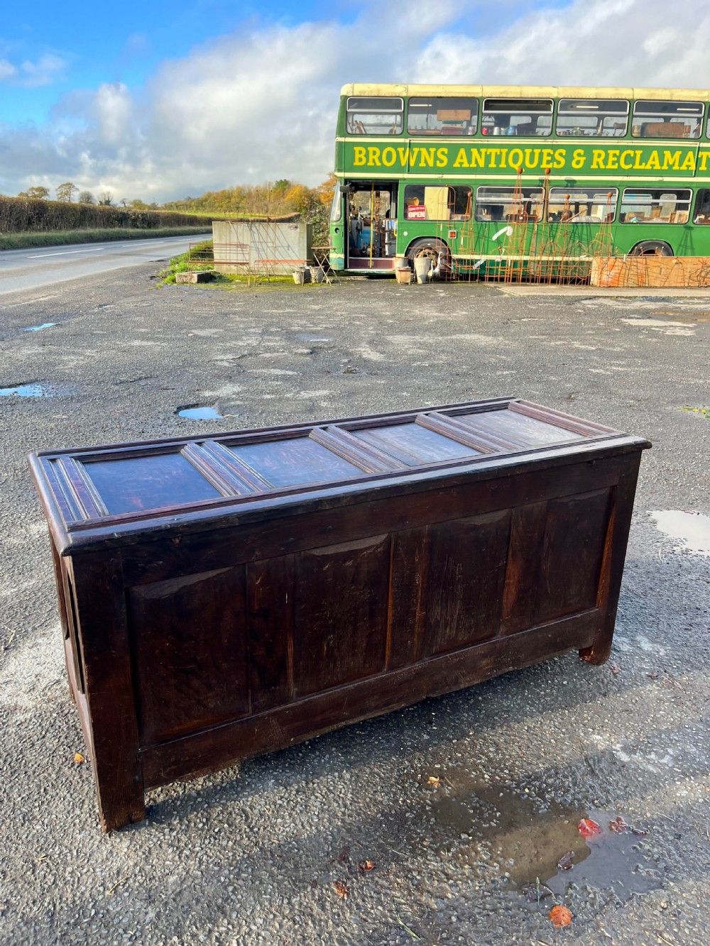 A large dark oak panelled coffer featuring four front panels decorated with raised diamond bosses and half-turned column mouldings. View III