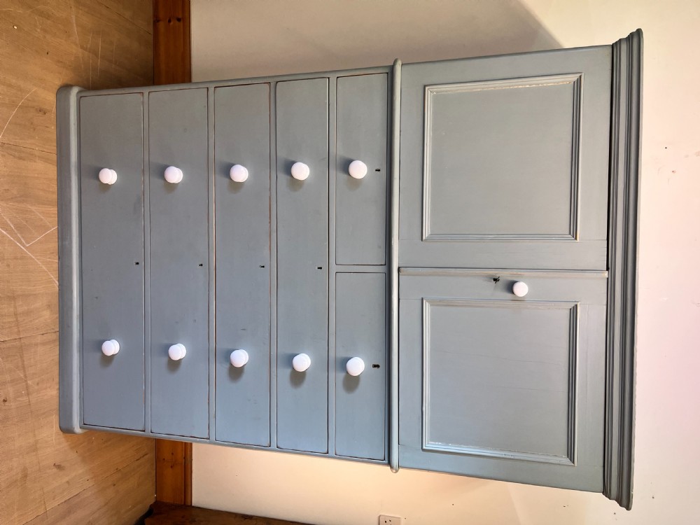 A tall Victorian painted pine linen cupboard featuring a top double-door cupboard set above five drawers with white turned handles. View III