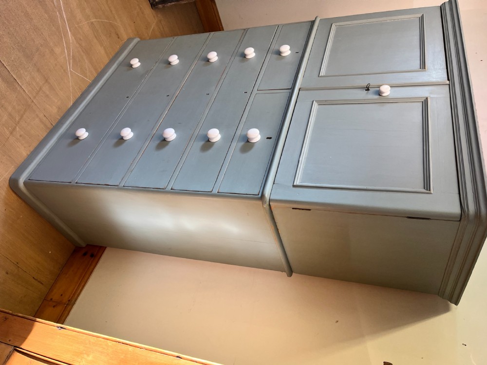 A tall Victorian painted pine linen cupboard featuring a top double-door cupboard set above five drawers with white turned handles. View V