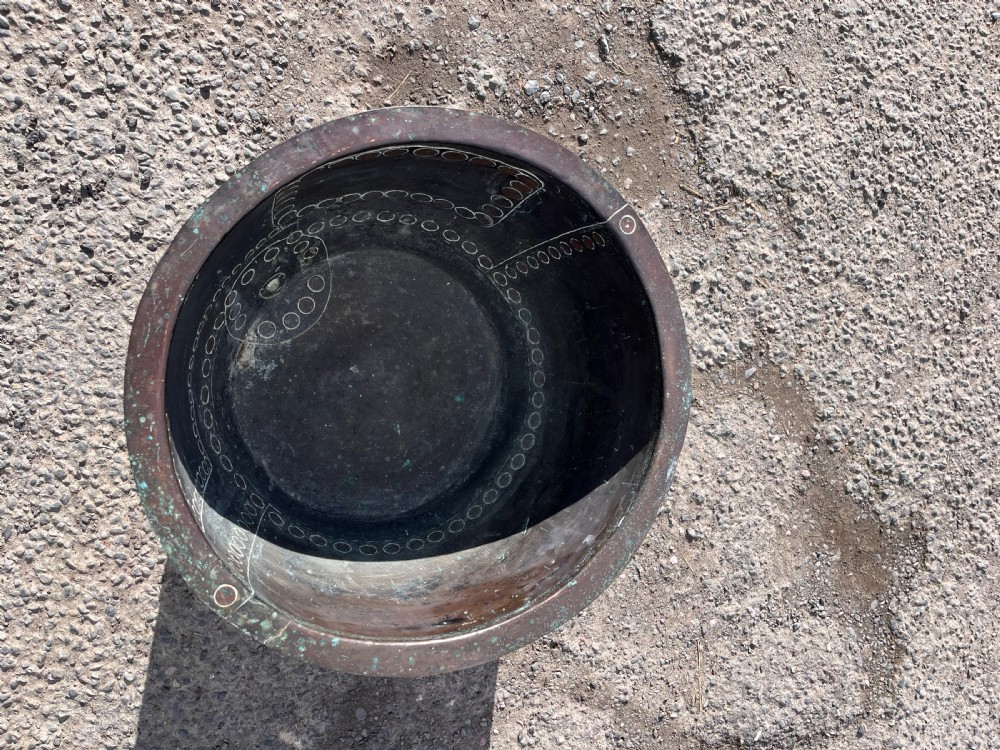 A large 19th-century copper wash boiler with heavy hand-hammered rivets along the seams and a dark oxidised patina. View II