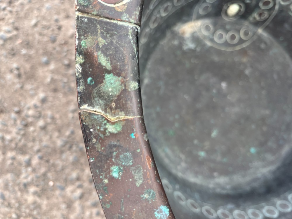 A large 19th-century copper wash boiler with heavy hand-hammered rivets along the seams and a dark oxidised patina. View V