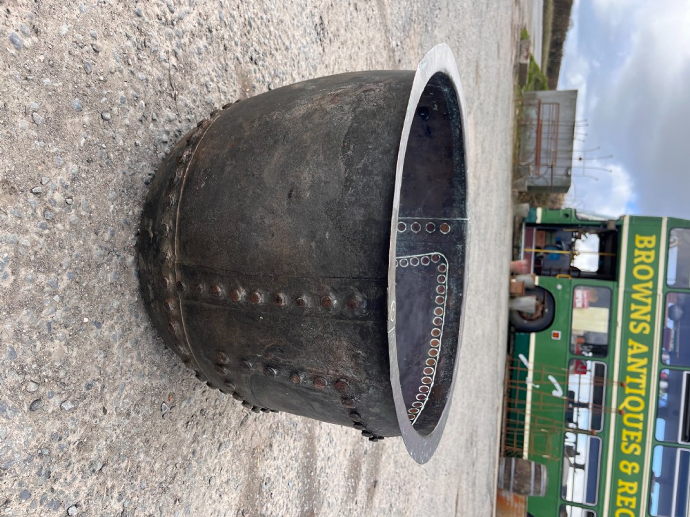 A large 19th-century copper wash boiler with heavy hand-hammered rivets along the seams and a dark oxidised patina. View VIII