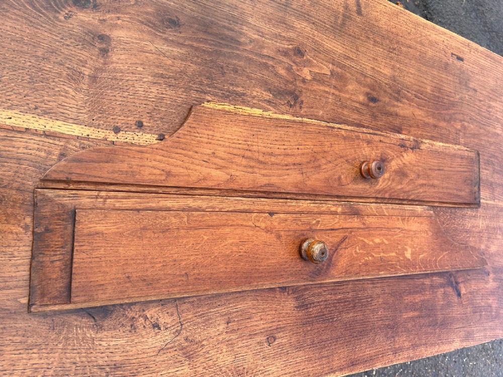 A long 19th-century solid oak serving table with three frieze drawers, simple wooden knobs, and a rectangular H-stretcher base. View XII