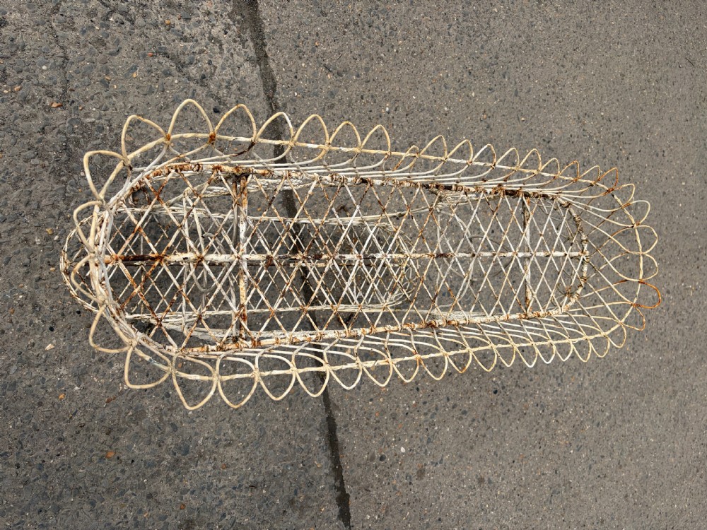 A two-tiered Regency era off-white painted wrought iron wirework plant stand with looped lattice borders and scrolling decorative supports. View IV