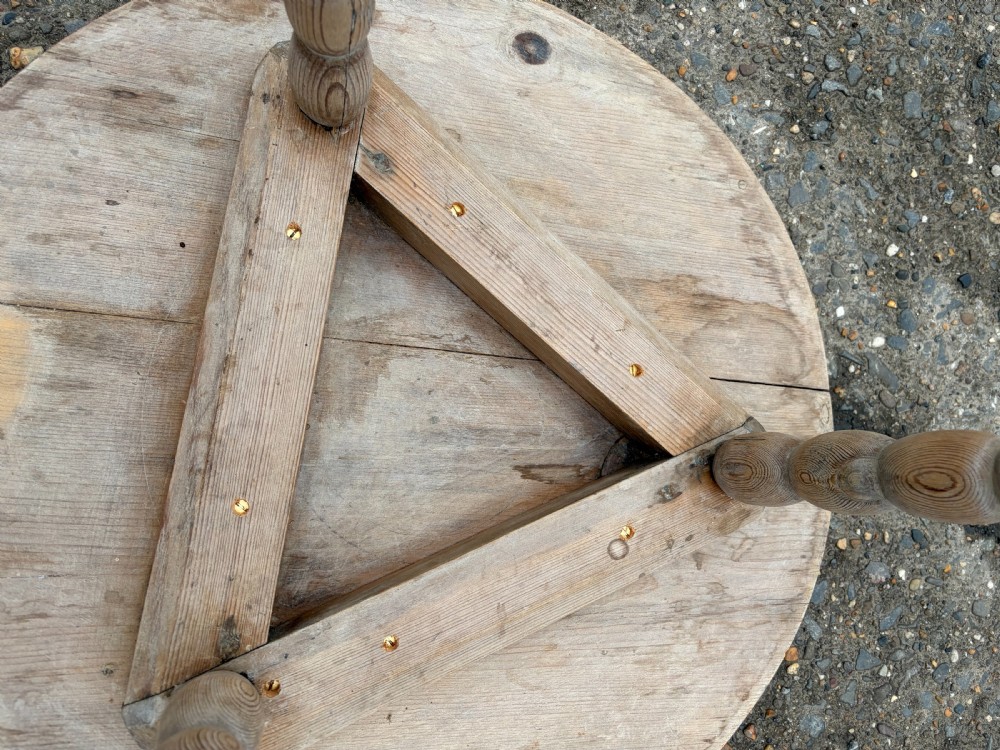 A nineteenth-century pine cricket table featuring a circular top supported by three bobbin-turned legs. View IV