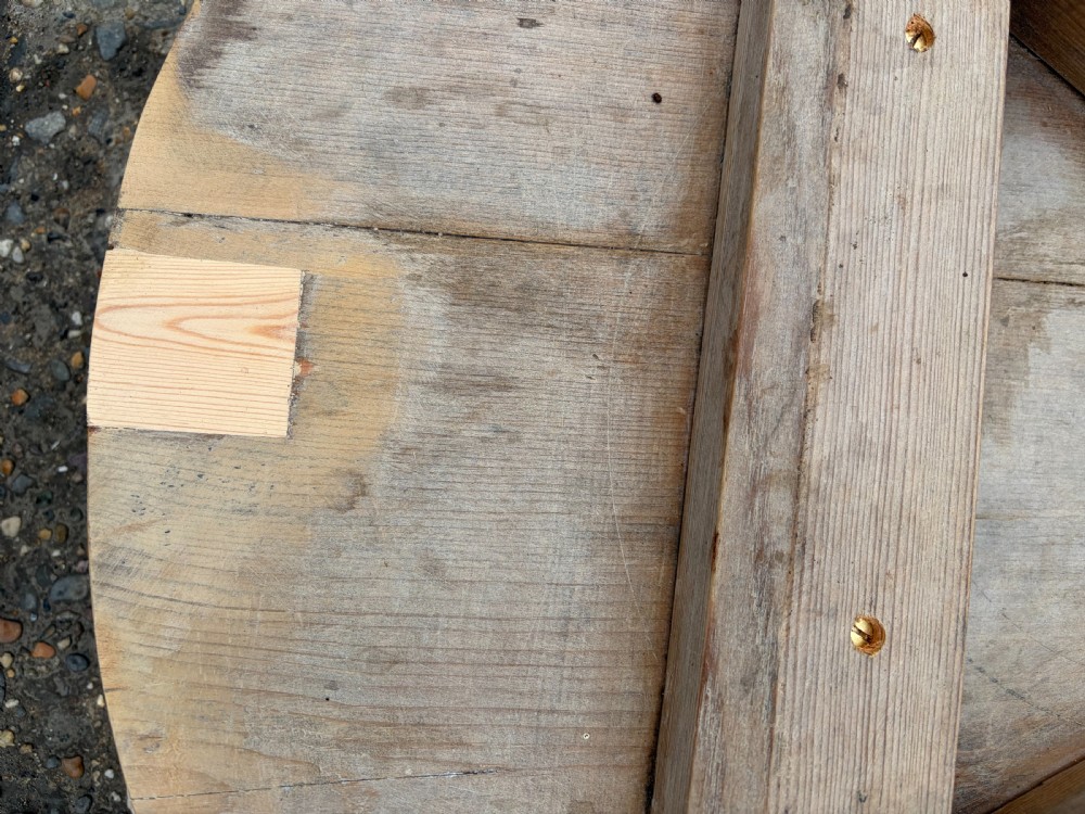 A nineteenth-century pine cricket table featuring a circular top supported by three bobbin-turned legs. View V