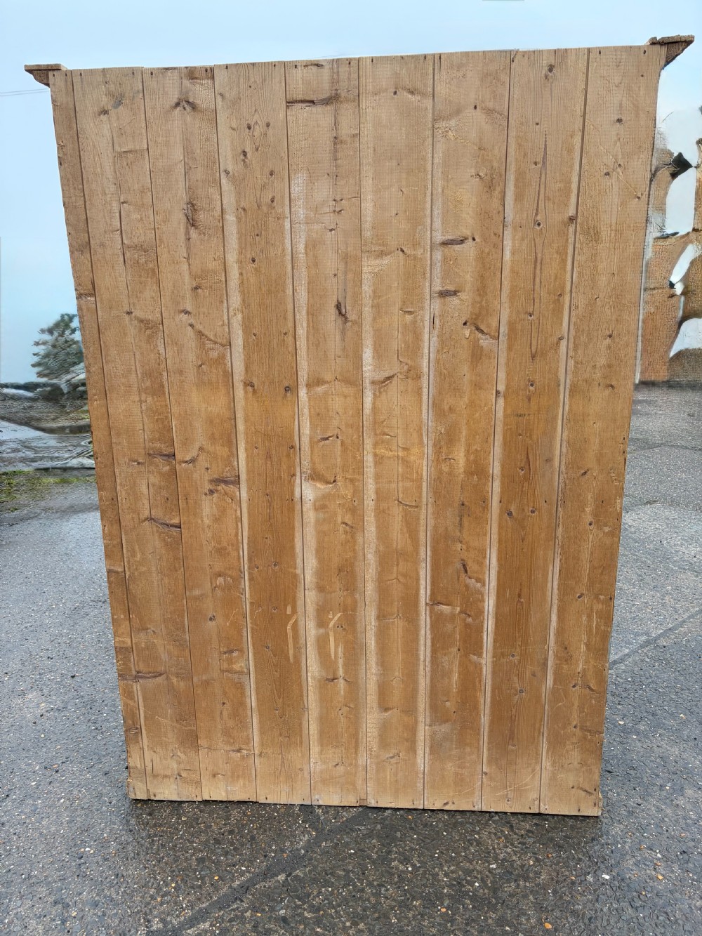 A tall Victorian pine cupboard with four framed panel doors, turned wooden knobs, and a natural waxed finish. View X