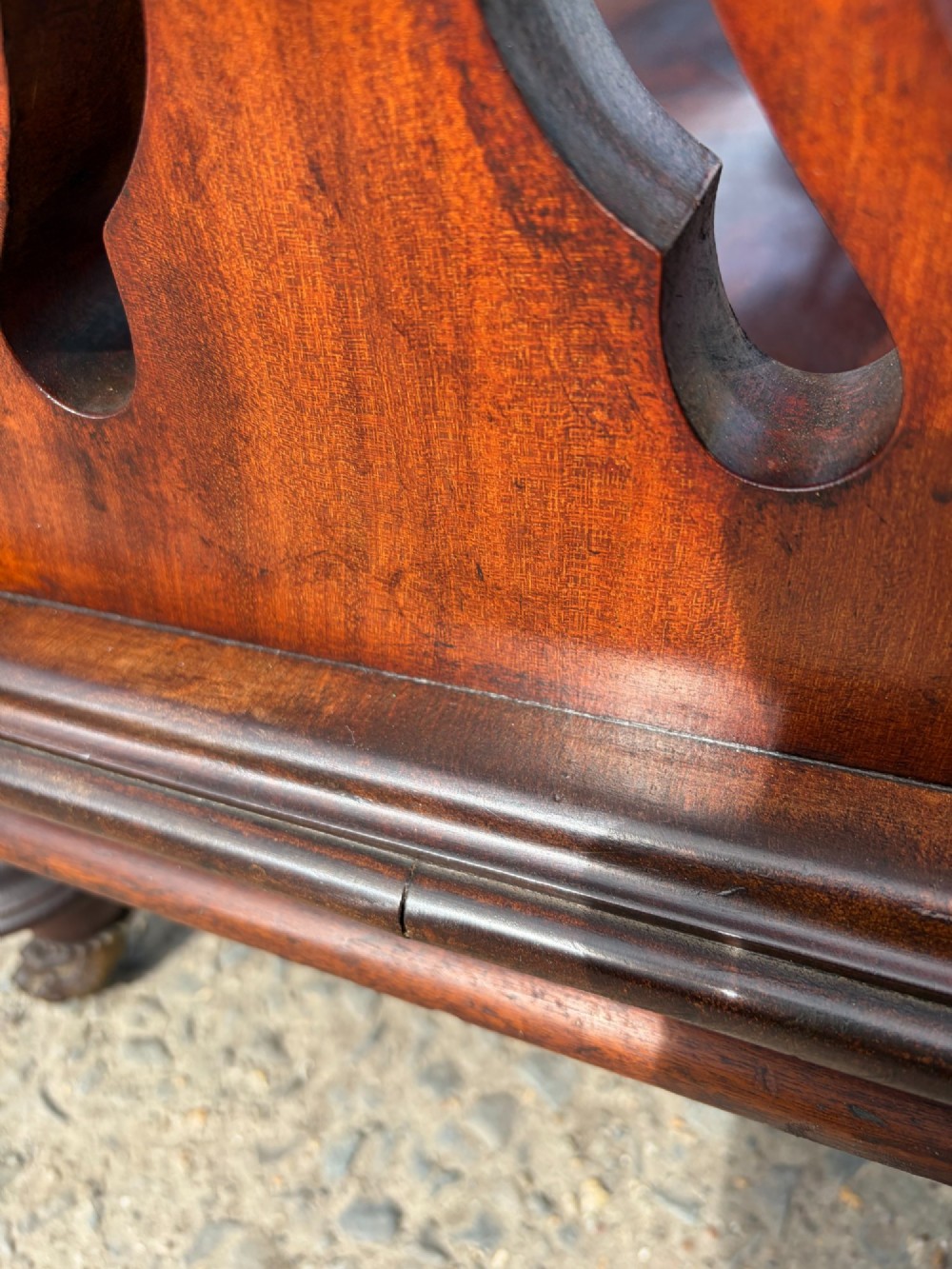 A Victorian mahogany three-tier buffet featuring carved pierced side supports, open rectangular shelves, and turned feet resting on original castors. View IX