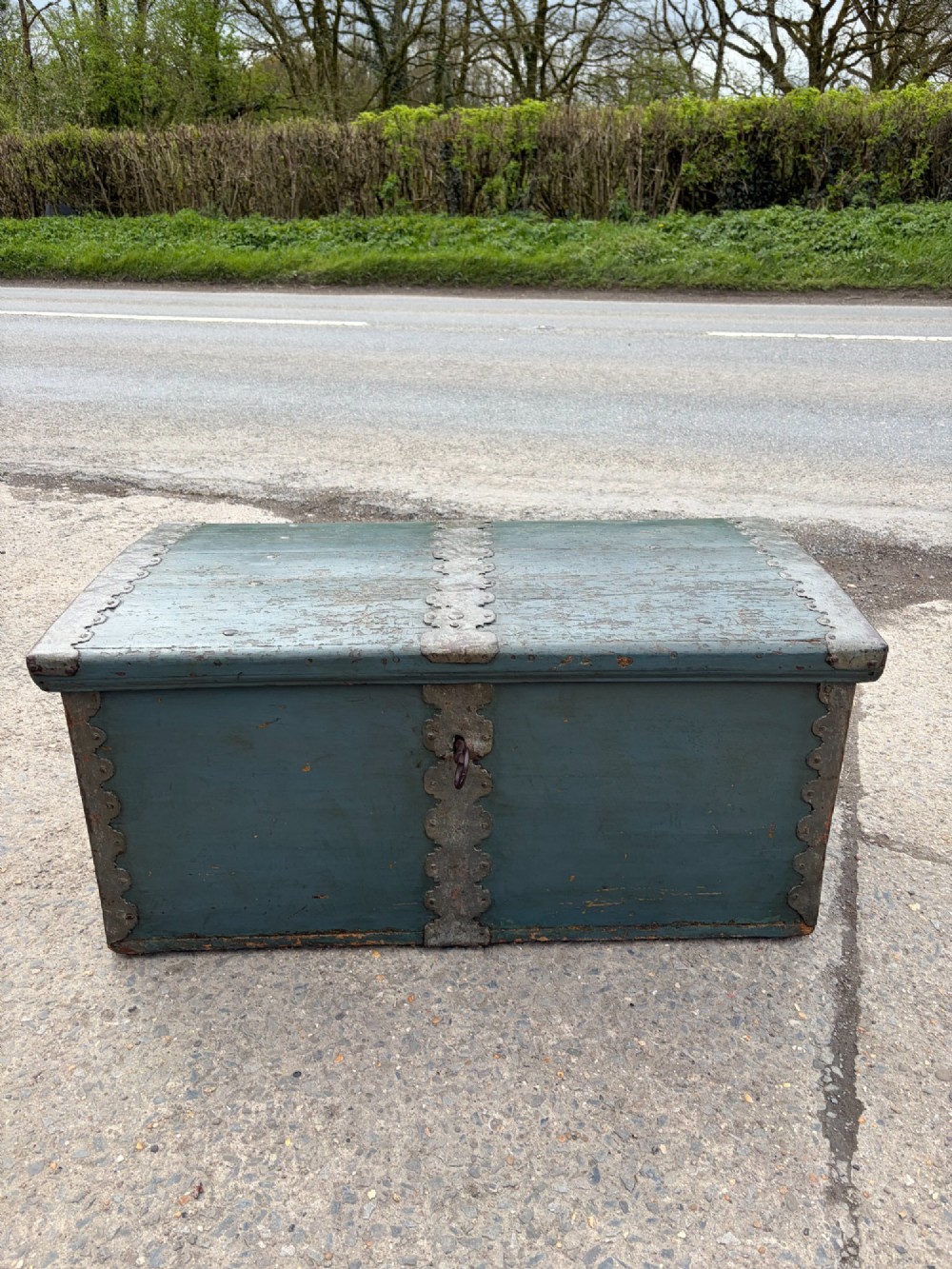 A 19th-century wooden storage chest featuring a curved dome lid, original blue-grey paint finish, and decorative iron strapwork.