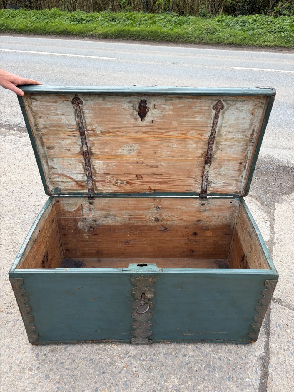A 19th-century wooden storage chest featuring a curved dome lid, original blue-grey paint finish, and decorative iron strapwork. View III