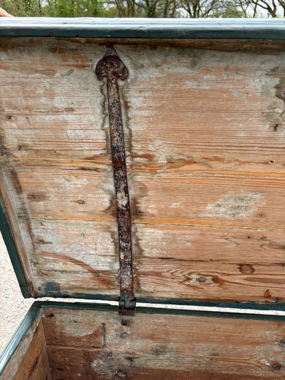 A 19th-century wooden storage chest featuring a curved dome lid, original blue-grey paint finish, and decorative iron strapwork. View V