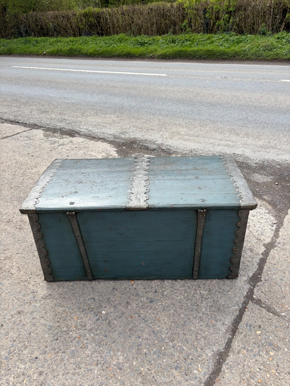 A 19th-century wooden storage chest featuring a curved dome lid, original blue-grey paint finish, and decorative iron strapwork. View VI