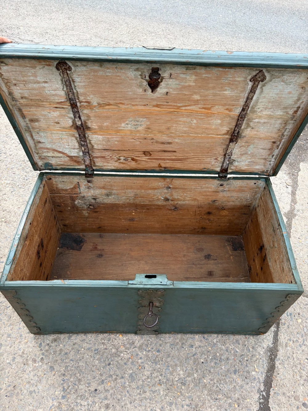A 19th-century wooden storage chest featuring a curved dome lid, original blue-grey paint finish, and decorative iron strapwork. View VII