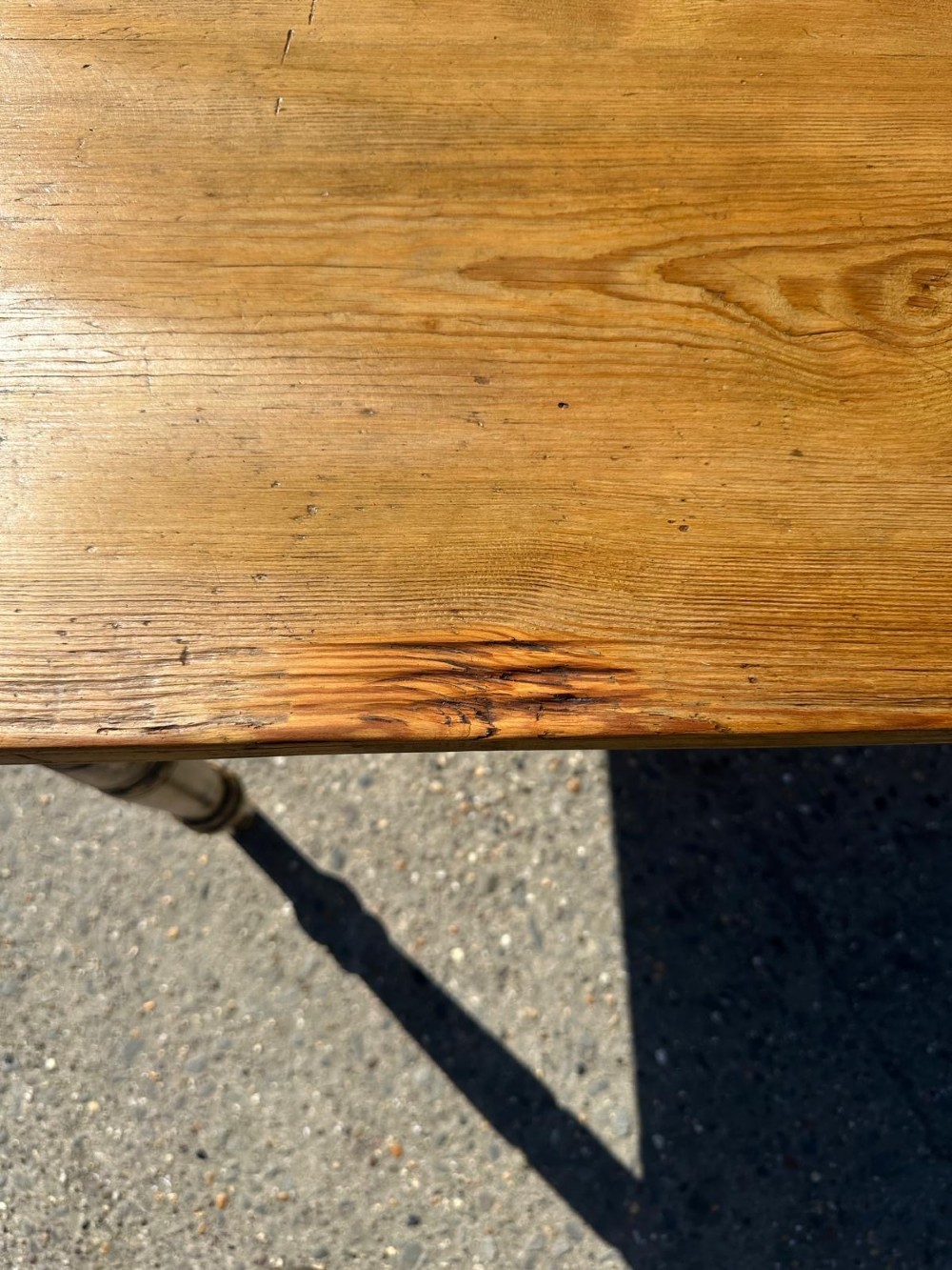A Victorian pine table featuring a natural wood top, a single drawer with a round wooden knob, and turned yellow painted legs showing light surface wear. View VII