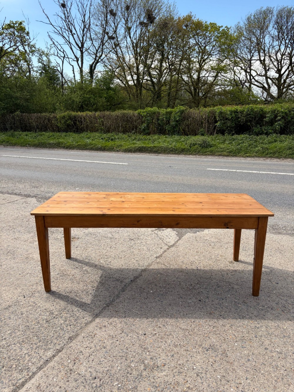 A rectangular Victorian pine table featuring four tapered square legs and a single drawer set into the front frieze.