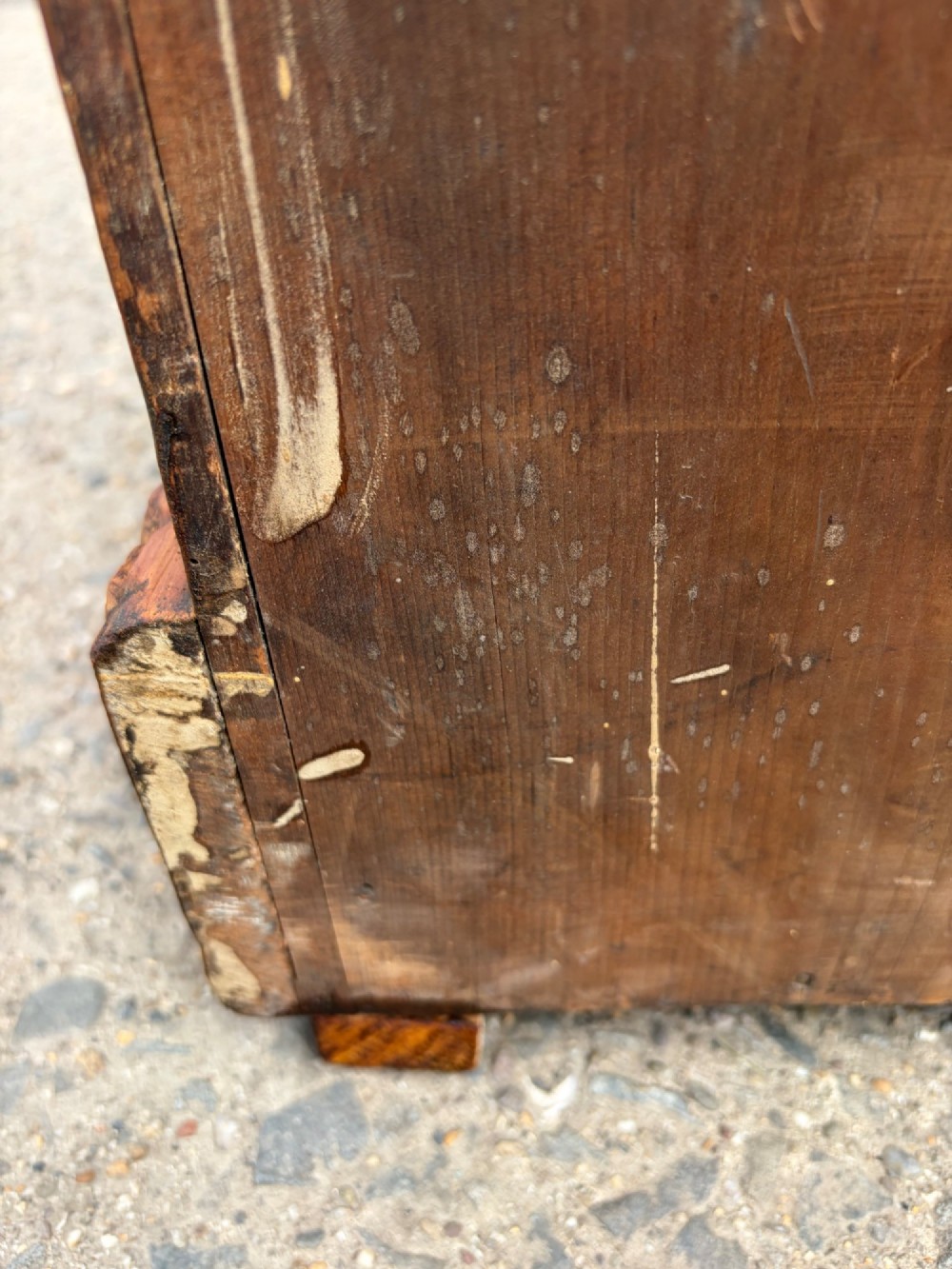 A Victorian pine chest of drawers featuring two short over three long graduated drawers with brass handles and carved edge trim. View III