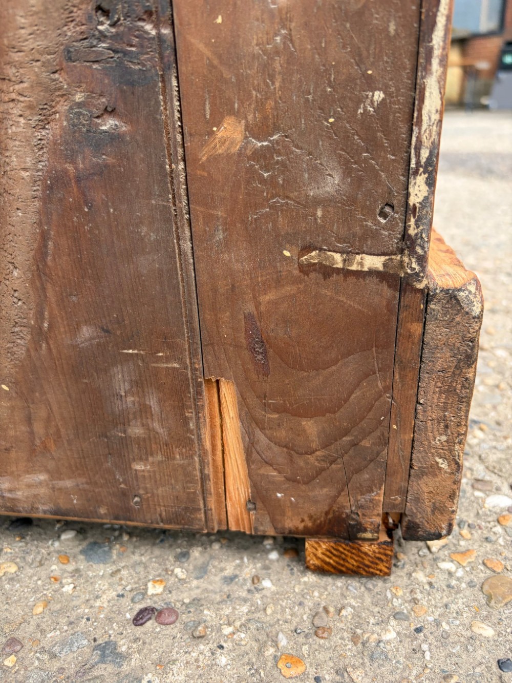 A Victorian pine chest of drawers featuring two short over three long graduated drawers with brass handles and carved edge trim. View IV