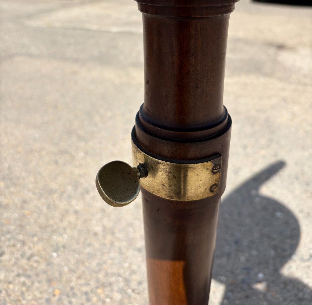 A Victorian mahogany telescopic shaving mirror with an oval mirror frame, central shelf, brass adjustment rod, turned column, and tripod base. View VIII