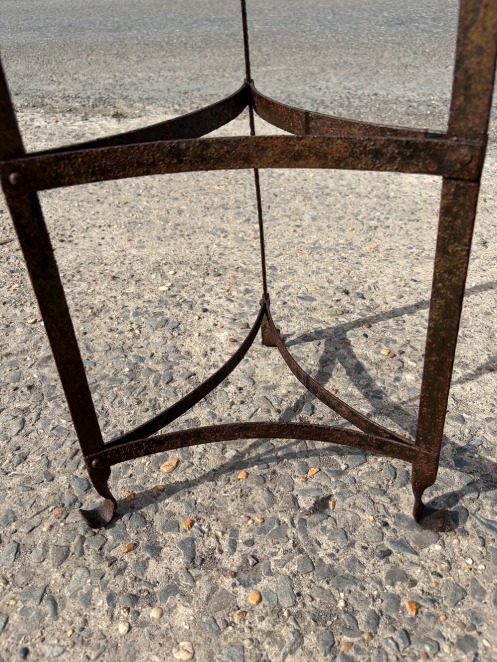 A tall nine-tiered wrought iron pan stand featuring graduated triangular tiers and scrolled detailing at the top. View IV